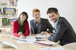 Real estate agent discussing property documents to his clients
