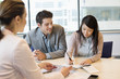 Couple signing documents with real estate agent