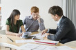 Real estate agent discussing property documents to his clients