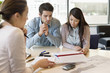Real estate agent discussing property documents to his clients