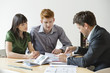 Real estate agent discussing property documents to his clients