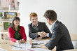 Real estate agent discussing property documents to his clients