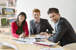 Real estate agent discussing property documents to his clients