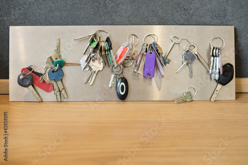 Photo: Assorted keys on a metal sheet Assorted keys on a metal sheet