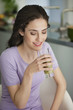 Woman holding a glass of cold soup and smiling