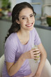 Woman holding a glass of cold soup and smiling