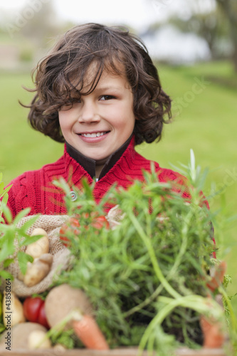Photo: Happy boy with a crate of homegrown vegetables Happy boy with a crate of homegrown vegetables