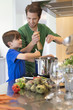 Boy assisting his father in the kitchen