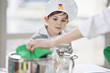 Boy helping his mother at dining table