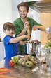 Boy assisting his father in the kitchen