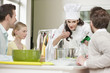 Female chef smelling food before serving