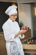 Woman holding a jar of tomato sauce
