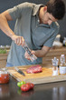 Man sprinkling black pepper on the meat