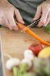Photo: Man cutting carrot Man cutting carrot