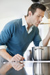 Man tasting food in the kitchen
