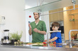 Man and son cutting vegetables in the kitchen