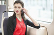 Woman traveling in a bus and talking on a mobile phone