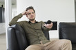 Man using remote control while watching television