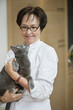 Woman holding a cat and smiling