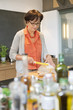Woman cutting bread in the kitchen