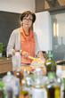 Woman cutting bread in the kitchen