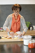 Woman applying butter on bread