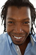 Close up portrait of a black Jamaican man with dreadlocks.