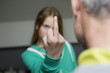 Girl showing middle finger to her father