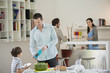 Man and son setting table for lunch