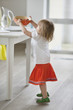 Girl setting bowl of food on a table