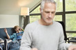 Close-up of a man with his son talking on mobile phone in background