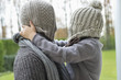 Man and son covering their faces with hats