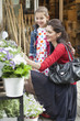 Woman and her daughter looking at flowers in a flower shop