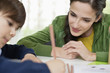Woman teaching her son at home