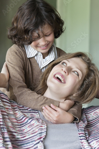 Photo: Close-up of a woman with his son smiling Close-up of a woman with his son smiling
