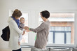 Nanny taking a baby girl from her mother