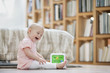 Baby girl playing with a musical block toy