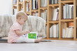 Baby girl playing with a musical block toy