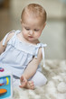 Baby girl playing with a musical block toy