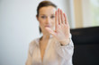 Businesswoman showing her wedding ring with stop gesture