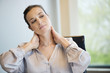 Close-up of a businesswoman suffering from neckache