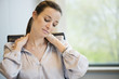Close-up of a businesswoman suffering from neckache