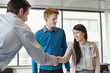 Business executive shaking hands with his clients