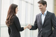 Business executives shaking hands in an office
