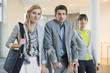 Disabled businessman standing with two women