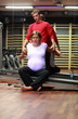 Physical therapist stretching ,pregnant woman's arms in gym