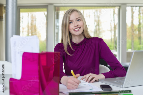 Photo: Happy businesswoman working in home office Happy businesswoman working in home office