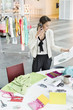 Female fashion designer talking on a mobile phone in an office