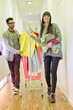 Fashion designers walking in a corridor with clothes rail