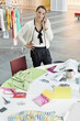 Female fashion designer talking on a mobile phone in an office